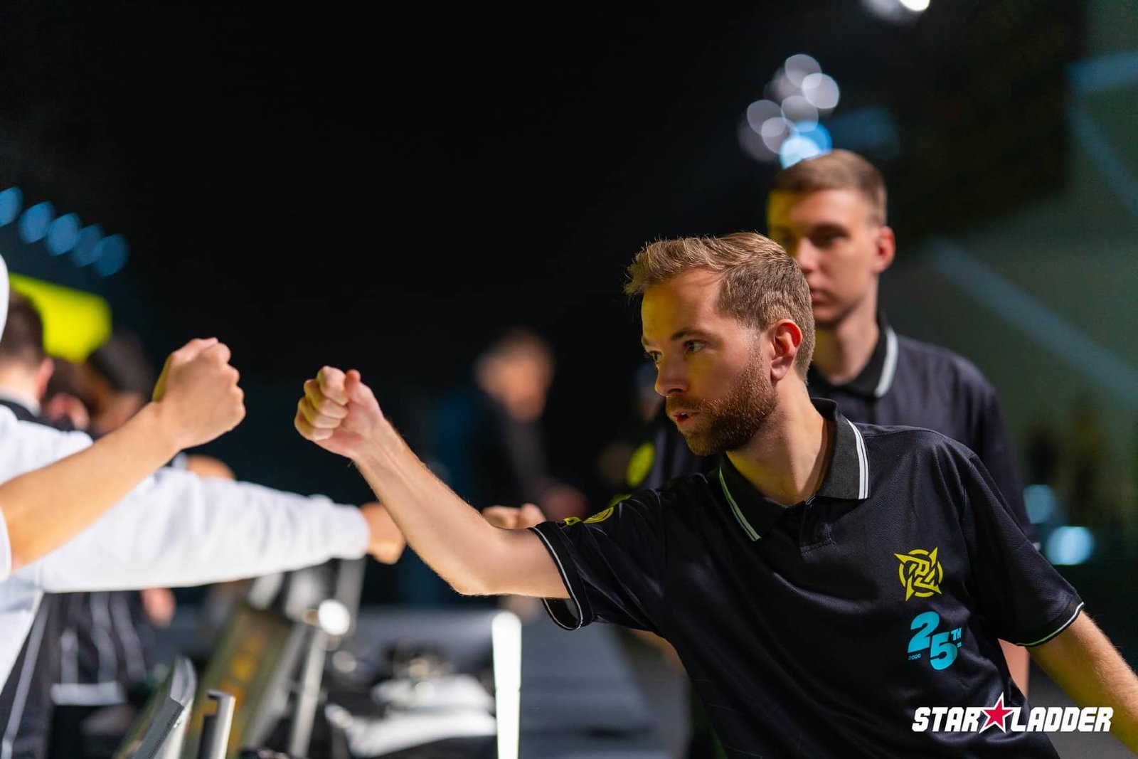 Image of Ninjas in Pyjamas Counter-Strike coach fist bumping at StarLadder Budapest Major 2025
