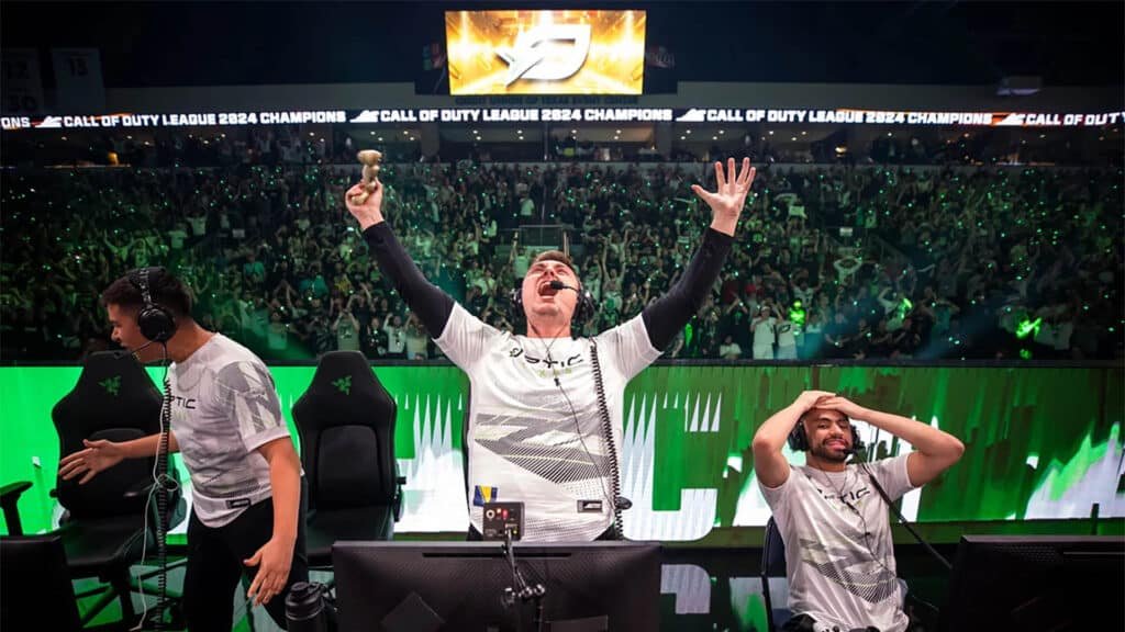 Image of OpTic Texas celebrating victory on stage at CDL Championship. Pred is screaming into the air with hands raised