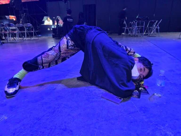 hayao showman posing on stage at evo